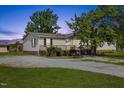 Inviting single-story home features a well-maintained yard, a gravel driveway, and a charming front porch with brick accents at 12294 Nc Hwy 96 S, Dunn, NC 28334