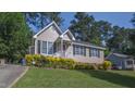 Quaint single Gathering home with manicured lawn, tidy landscaping and easy driveway access at 133 Parkhaven Ln, Garner, NC 27529