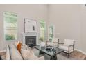 Bright living room with high ceilings, fireplace, neutral colors, and modern furnishings at 161 Walking Path Pl, Hillsborough, NC 27278