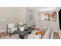 Cozy living area showcasing stylish decor, neutral color palette, and seamless flow into the kitchen at 161 Walking Path Pl, Hillsborough, NC 27278