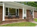 Inviting front porch with rocking chairs, perfect for relaxing outdoors at 1837 Garrett House Trl, Burlington, NC 27215