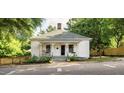 Charming one-story home featuring a welcoming front porch, mature trees, and landscaping at 203 Brick St, Wake Forest, NC 27587