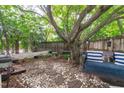 Secluded backyard oasis with lush greenery, stone path, and charming swing at 2112 Tulare Ct, Raleigh, NC 27612
