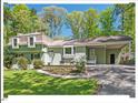 Charming home with a well-manicured lawn, established plantings and a convenient covered carport at 216 Brook Ln, Durham, NC 27712