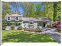 Charming home with a well-manicured lawn, established plantings and a convenient covered carport at 216 Brook Ln, Durham, NC 27712