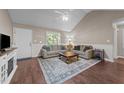 Cozy living room featuring vaulted ceilings, a ceiling fan, and a comfortable seating area with stylish decor at 300 Plantation Rd, Clayton, NC 27520