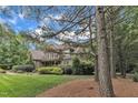 Beautiful home with stone and shingle exterior, manicured landscaping, and mature trees at 3007 Krogen Ct, Creedmoor, NC 27522