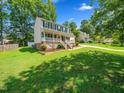 Side view of a two-story home with a well-maintained lawn and mature trees at 3025 Creek Moss Ave, Wake Forest, NC 27587