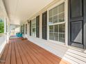 Spacious porch with wood flooring and classic black shutters at 3025 Creek Moss Ave, Wake Forest, NC 27587