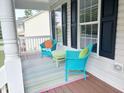 Cozy porch seating area with colorful furniture and a decorative rug at 3025 Creek Moss Ave, Wake Forest, NC 27587