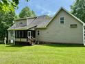 Side and rear exterior view of house with porch and mature trees at 327 Beavertail Rd, Henderson, NC 27537
