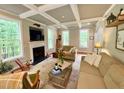 Bright living room with coffered ceiling, fireplace, and large windows at 327 Beavertail Rd, Henderson, NC 27537