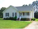 Inviting one-story home featuring a cozy front porch and a well-maintained yard at 3803 Ridgewood Dr, Franklinton, NC 27525