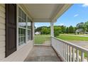 Relaxing front porch with white railings and a view of the green lawn at 3803 Ridgewood Dr, Franklinton, NC 27525