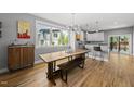 Bright dining area features modern lighting, hardwood floors, and large window overlooking the neighborhood at 409 E Lee St, Raleigh, NC 27601