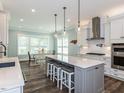 Spacious kitchen featuring an island with barstool seating, modern appliances, and ample counter space at 4104 Bankshire Ln, Raleigh, NC 27603