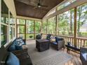 Relaxing screened-in porch featuring comfortable seating and views of the surrounding greenery at 4104 Bankshire Ln, Raleigh, NC 27603