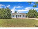 Quaint one-story home featuring a well-maintained lawn and traditional architectural details at 430 Sir David Dr, Zebulon, NC 27597