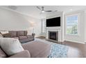 Inviting living room with fireplace, large TV, and stylish blue patterned rug at 4420 Bonnie Loch Dr, Burlington, NC 27215