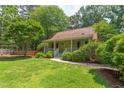 View of a charming single-Gathering home surrounded by lush green trees, with a well-maintained lawn and a inviting walkway at 520 Brittany Bay W, Raleigh, NC 27614