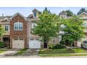 Beautiful townhouse with a two-car garage and manicured lawn at 520 Camden Yards Way, Cary, NC 27519