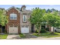 Beautiful townhouse with a two-car garage and manicured lawn at 520 Camden Yards Way, Cary, NC 27519