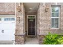 Charming brick home featuring a decorative front door and garage at 520 Camden Yards Way, Cary, NC 27519
