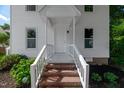 Inviting front entrance with brick steps and classic white railings leading to the front door at 5236 Turf Grass Ct, Raleigh, NC 27610