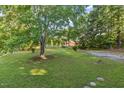 Expansive front yard with mature trees offering ample space and natural beauty, enhancing curb appeal at 586 New Hope Church Rd, Apex, NC 27523