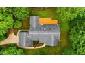Aerial view showcases the well-maintained roof and large wooden deck surrounded by lush greenery at 5939 Florasaline Dr, Mebane, NC 27302