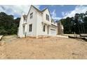 New construction home featuring white brick and siding, and a side-entry two car garage at 6501 Burnette Flower Way, Raleigh, NC 27612