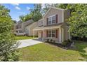 View of charming home with landscaped yard, long driveway and attached garage at 6604 Frogstool Ln, Raleigh, NC 27610