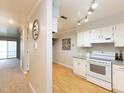 Open kitchen and dining area features wood floors and modern white appliances at 7353 Sandy Creek Dr, Raleigh, NC 27614