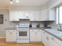 Bright kitchen with white cabinets, neutral countertops, and modern appliances at 7353 Sandy Creek Dr, Raleigh, NC 27614