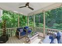 Relaxing screened-in porch features comfortable seating, a ceiling fan, and string lights overlooking a lush, green yard at 776 Legend Oaks Dr, Chapel Hill, NC 27517