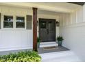 Inviting front porch with double doors, decorative plants, and stylish accents at 813 Faulkner Pl, Raleigh, NC 27609