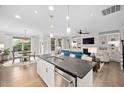 Open-concept kitchen featuring a large island with stainless steel appliances, and views of the dining area and living room at 829 Churton Pl, Cary, NC 27518