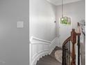 Elegant entryway with a curved staircase, chandelier, and front door with window at 8722 Macedonia Lake Dr, Cary, NC 27518