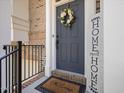 Close-up of a front door with wreath, doormat and 'Home Sweet Home' sign at 8722 Macedonia Lake Dr, Cary, NC 27518