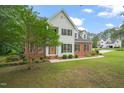Beautiful two-story house with a well-maintained lawn and landscaping in a peaceful neighborhood setting at 1005 Barmkin Pl, Knightdale, NC 27545