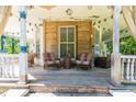 Inviting porch featuring wood floors, seating and string lights at 110 E Church St, Creedmoor, NC 27522