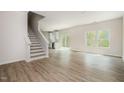 Open concept living room and kitchen offer an inviting space with wood-look floors and natural light at 112 Hays St, Oxford, NC 27565