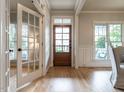 Light-filled entryway showcasing hardwood floors, a charming wood door and a glass paneled door at 1206 Chalk Maple Dr, Cary, NC 27519