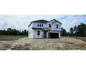 New two-story home with Tyvek wrap in a serene setting, surrounded by lush trees at 127 Caspian Ct, Lillington, NC 27546