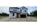 Two-story home with Tyvek wrap awaiting finishing touches in a spacious lot at 127 Caspian Ct, Lillington, NC 27546