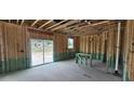 Unfinished living room featuring sliding glass doors and open stud construction at 127 Caspian Ct, Lillington, NC 27546