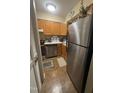 Galley kitchen featuring stainless steel appliances, wooden cabinets, and complementary countertops at 130 Beechwood Dr, Carrboro, NC 27510