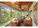 Beautiful sunroom filled with natural light, ceiling fans, and comfortable seating at 1401 Brewer Jackson Ct, Wake Forest, NC 27587