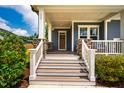 Inviting covered front porch with stone supports and classic white railing details at 152 Chauncey Cir, Chapel Hill, NC 27516