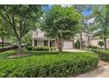 View of a beautiful home with lush landscaping, mature trees, and a well-maintained lawn at 1608 Heritage Links Dr, Wake Forest, NC 27587